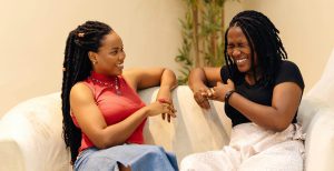 Woman talking to her mum while sitting on the sofa together