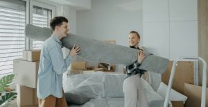 A couple moving a rug into their new home together
