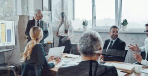Business owners giving a presentation in a board room meeting