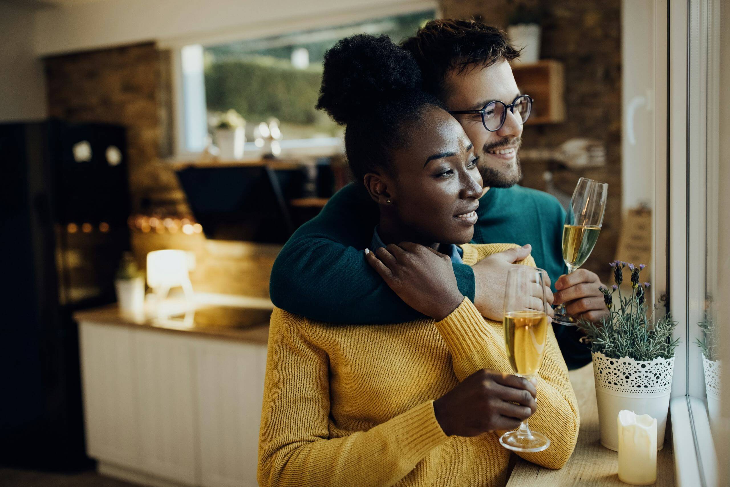 A couple drinking champagne in their new home after securing a mortgage with a mortgage advisor