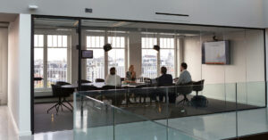 Four people sitting in a boardroom having a meeting at work