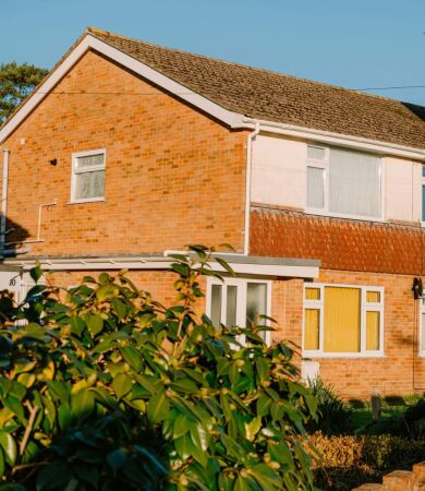 Brick houses with green bushes and clear blue sky