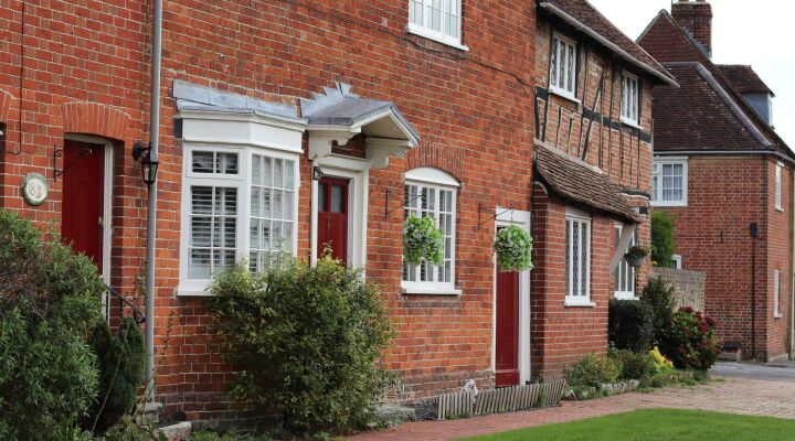 A row of traditional brick houses with red doors