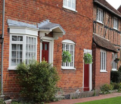 A row of traditional brick houses with red doors