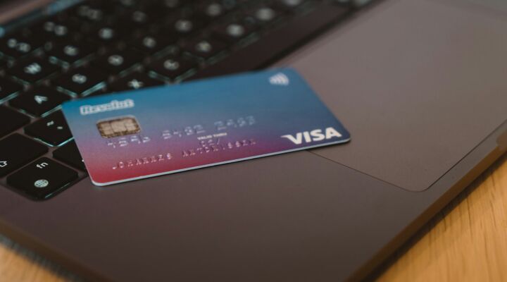 Credit card sitting on top of a laptop