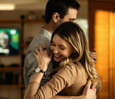 Young couple hugging each other in the living room