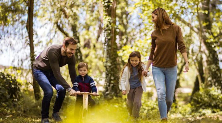 Parents playing with their children in the woods