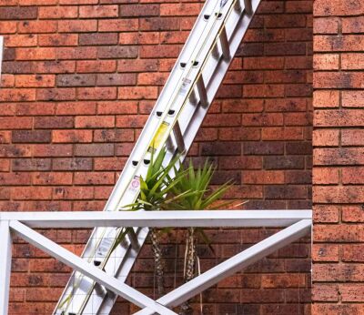 A ladder going from someone's balcony to the roof