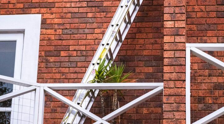A ladder going from someone's balcony to the roof