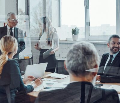 Business owners giving a presentation in a board room meeting