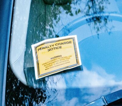A car with a parking ticket on its