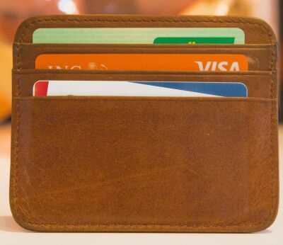 Three credit cards in a brown leather wallet