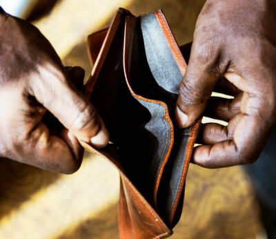 A person opening an empty wallet
