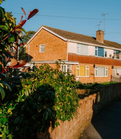 Brick houses with green bushes and clear blue sky