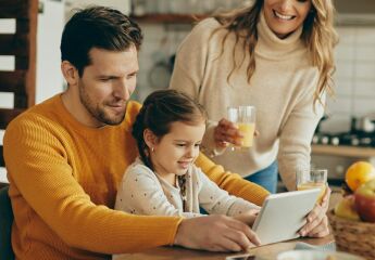 A couple trying to sort out their remortgage online while having breakfast in their kitchen