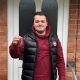 Jack Tucker - First-Time Buyer client of The Levels Financial standing outside of his new house while holding up the keys