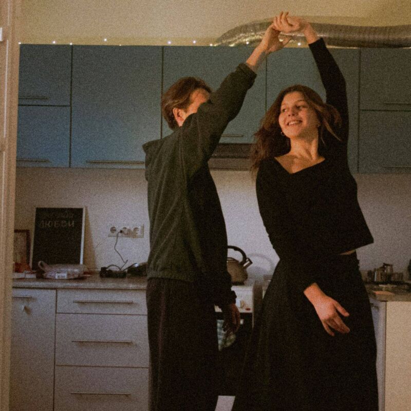 Two first-time buyers dancing in the kitchen after buying their first house with the help of a mortgage broker