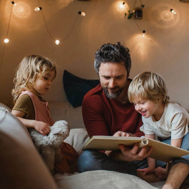 A dad reading to his two children