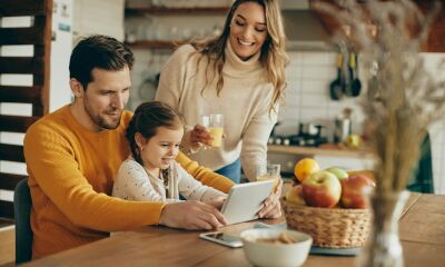 A couple trying to sort out their remortgage online while having breakfast in their kitchen