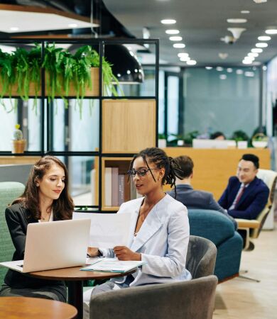 Two female business owners having a discussion in a meeting room