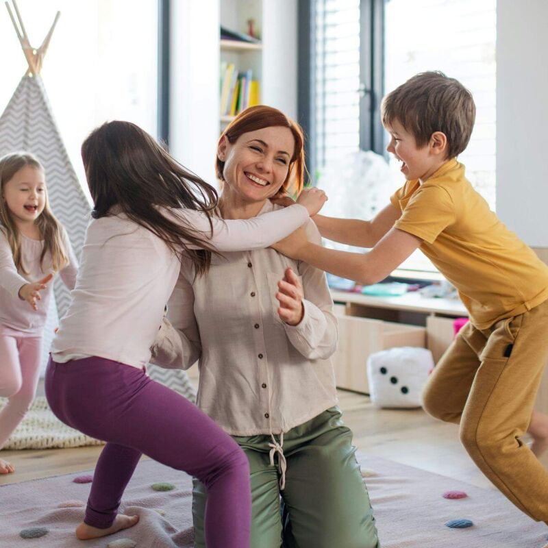 A mum playing with her three kids